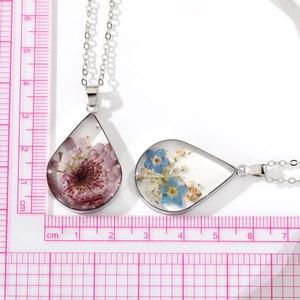 Teardrop dried flower pendant necklace with purple daisy and gold foil on scale