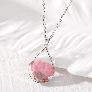 Water drop shaped resin necklace with real pink dried flowers and gold leaf foil details