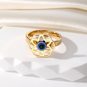 Bague vintage fleur évidée œil protecteur en métal doré avec perle bleue centrale