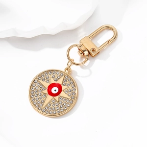 Macro shot of gold devil eye keychain with sparkling rhinestones and lobster clasp