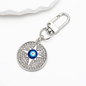 Detailed view of silver evil eye keychain with sparkling rhinestones and lobster clasp