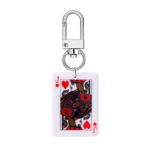 Close-up of creative mini playing card keychain with red hearts Jack on acrylic material