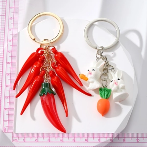 Cute resin keychains featuring red chili pepper string and white bunnies with carrot