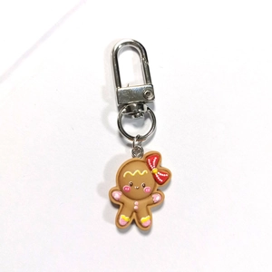 Cute gingerbread man Christmas keychain with silver lobster clasp on white background