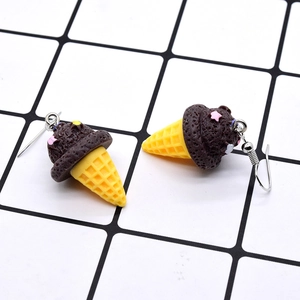 Cute resin ice cream cone earrings with chocolate scoops and star details on grid background