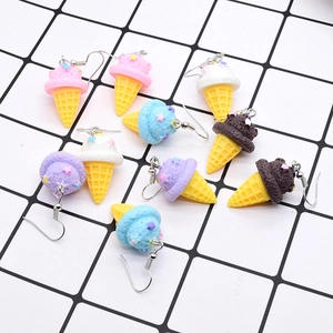 Colorful resin ice cream cone dangle earrings with tiny stars on grid background