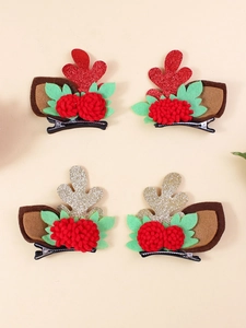 Detail view of Christmas antler hair clips with glitter, felt leaves and plush pom-poms