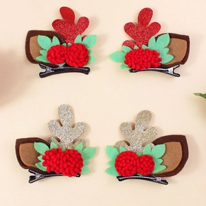 Set of four festive reindeer antler hair clips with glitter details and plush pom-poms