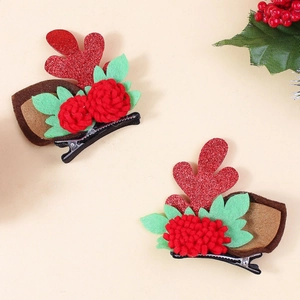 Cute Christmas reindeer antler hair clips with glitter plush balls and floral details