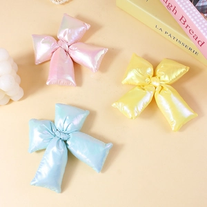 Three-piece large 3D padded bow accessories in glossy pink, yellow, and blue shiny fabric