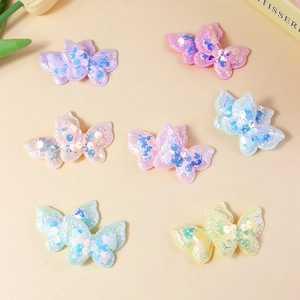 Sparkly sequin butterfly appliques in pastel colors for DIY hair accessories and crafts