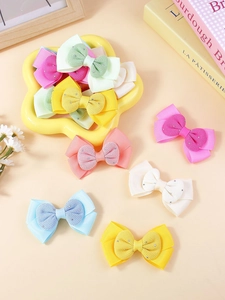 Détail du lot de 12 barrettes à nœuds pour filles en ruban gros-grain coloré et cristaux