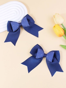 Detail of navy blue layered glitter hair bows with ribbed texture and silver rhinestones