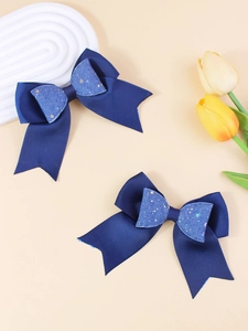 Close-up of double-layer glitter bow hair clips with navy blue grosgrain ribbon