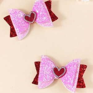 Paio di fermagli per capelli a fiocco glitter rosa e rosso con cuore di strass