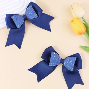 Navy blue glitter double-layered bow hair clips on minimalist beige background