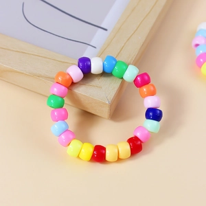 Bohemian multicolored beaded bracelet featuring vibrant cylinder beads on a wooden frame