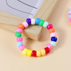 Macro shot of colorful bohemian style acrylic beaded bracelet on warm background