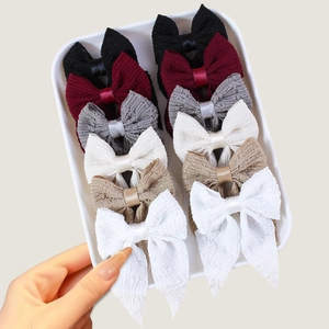 Set of 10 elegant pleated bow hair clips in various colors including black and beige