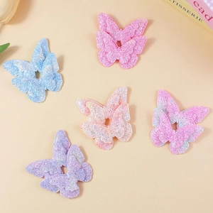 Sparkly glitter butterfly hair clips for kids in blue, pink, and purple gradient colors