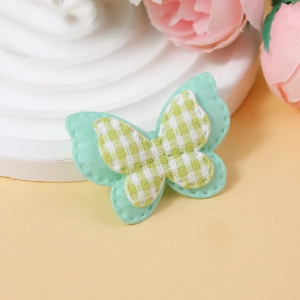 Close-up of yellow checkered butterfly fabric patch applique for DIY hair accessories