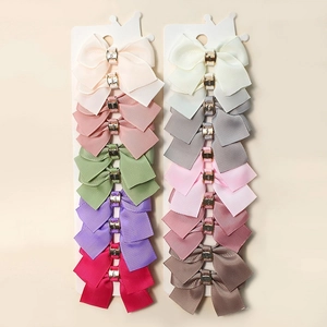 20-piece set of colorful ribbon bow hair clips with gold buckles on display cards