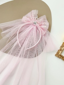Detail of pink princess headband with crown, mesh bow and golden star sequins