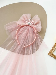 Close-up of pink princess headband with crown, mesh veil and gold star sequins