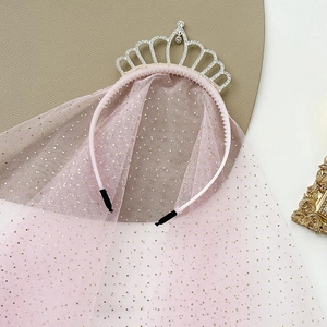 Macro detail of pink princess headband with silver rhinestone crown and sparkling mesh veil
