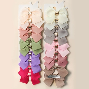 Detailed view of 20-piece colorful grosgrain ribbon bows with golden metal buckles