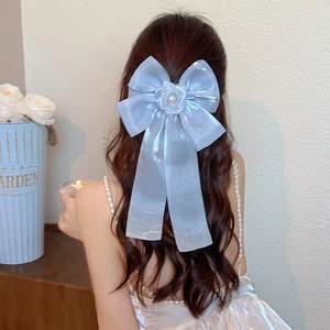 Elegant light blue silk bow hair clip with white pearl rose flower on model's hair