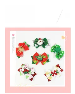 Detail view of various Christmas hair clips with sequins and festive bow designs