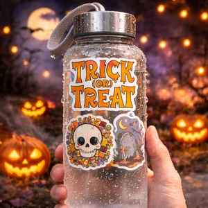 Close-up of Halloween stickers with skull and pumpkin icons on a frosted water bottle
