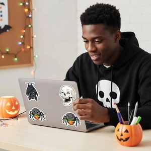Halloween cartoon stickers set applied on laptop cover with festive party decorations
