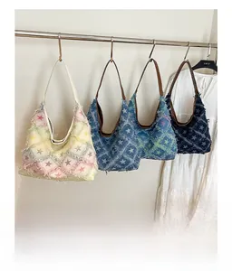 Detail of star pattern denim tote bags with frayed edges in four vintage color options