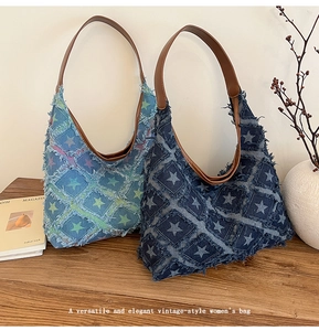 Detailed close-up of blue denim hobo bags with star patchwork and leather straps