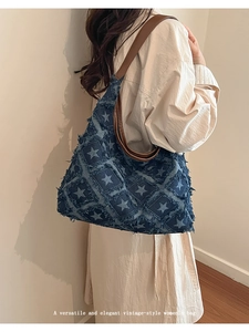 Close-up of vintage denim tote bag with star pattern and frayed edge details