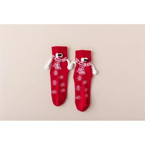 Détail de chaussettes rouges magnétiques avec mains 3D et motifs de flocons