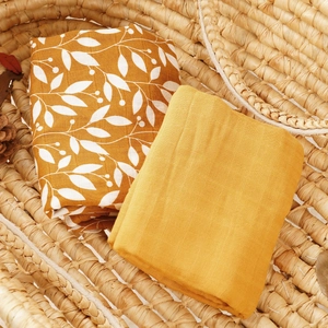 Muslin cotton baby swaddle blanket set in ginger yellow with botanical leaf pattern