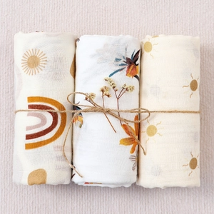 Three pack bohemian muslin baby swaddle blankets with rainbow and sun patterns