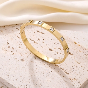 Polished gold titanium steel bangle with five square-cut cubic zirconia stones