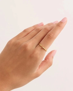 Macro detail of gold adjustable ring featuring star charms with white rhinestones
