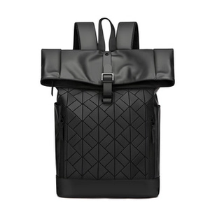 Macro view showing the intricate 3D geometric triangular pattern on the black leather bag