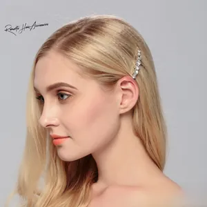 Close-up of sparkling rhinestone hair clip on a model showing elegant curved design