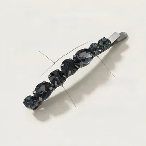 Detail of gunmetal hair clip featuring seven dark grey prong-set glass crystals