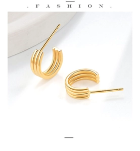 Detailed view of gold S925 sterling silver hoop earrings with triple layered ribbed design