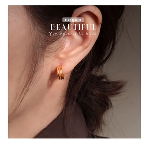 Close-up of triple-layer gold geometric S925 sterling silver hoop earrings on model