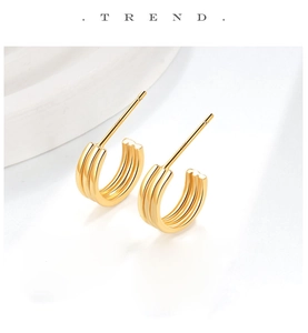 Detailed view of gold S925 sterling silver stud earrings with triple line C-shape design