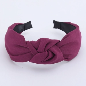 Detail view of purple wide headband featuring premium twill fabric and twisted knot design