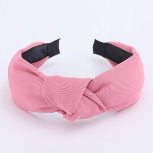 Detail of light pink top knot headband showing high-quality twill fabric texture
